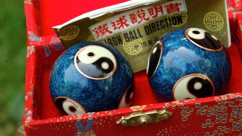 Zwei Klangkugeln (Qigong) mit Yin-Yang-Motiven in einem Kästchen