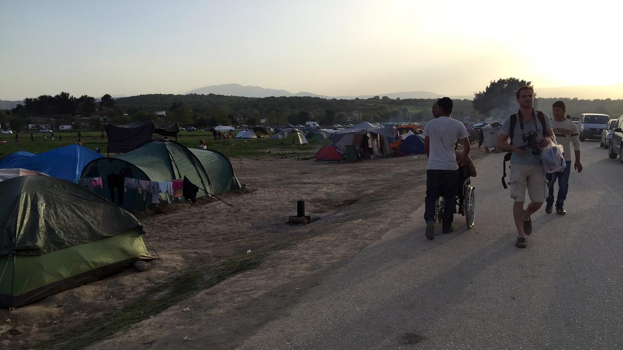 Ein Fotograf zwischen den Zelten im Flüchtlingslager Idomeni