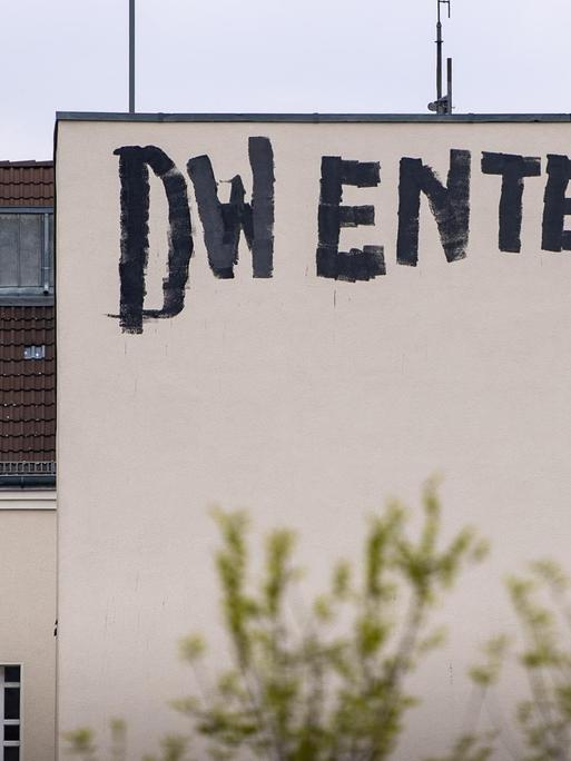 Ein Graffito "DW enteignen" prangt an der Brandmauer eines Wohnhauses im Berliner Bezirk Westend