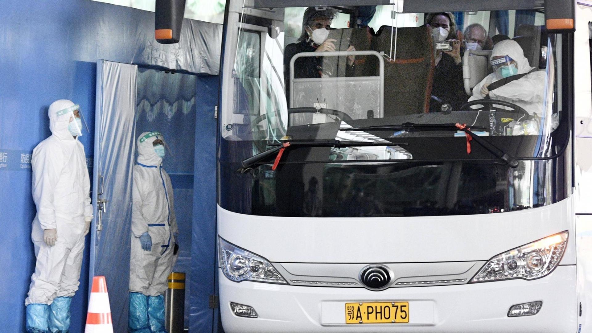 A bus carrying a team of experts from the World Health Organization departs an airport in Wuhan on Jan. 14, 2021, after arriving in the Chinese city to investigate the origins of the novel coronavirus. The 10-member team is expected to conduct the research in Wuhan, where Chinese authorities reported the first coronavirus case in December 2019, for about two weeks, after being quarantined at a local hotel for about two weeks.