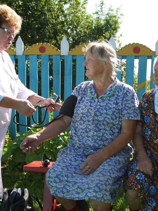 Eine Landärztin mißt den Blutdruck einer älteren Frau
