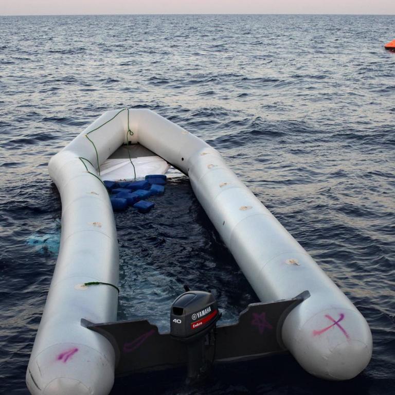 Seenotrettung von Bootsflüchtlingen vor der libyschen Küste Zivile Seenotrettung von Bootsflüchtlingen im Mittelmeer vor Libyen - an Bord des Seenotkreuzers Minden der Organisation LIFEBOAT: Havariertes Flüchtlingsboot . Sein Boden ist ausgebrochen, viele Afrikaner trieben im Wasser, mindestens 2 Menschen sind ertrunken. Im Hintergrund zu sehen: Von der Minden ausgebrachte Rettungsinsel. Mittelmeer, vor libyscher Küste, Internationale Gewässer, 20.10.2016.