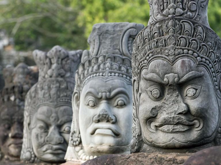 Eine Reihe von Dämonen-Statuen entlang der Balustrade vor dem Südtor von Angkor Thom in Kambodscha