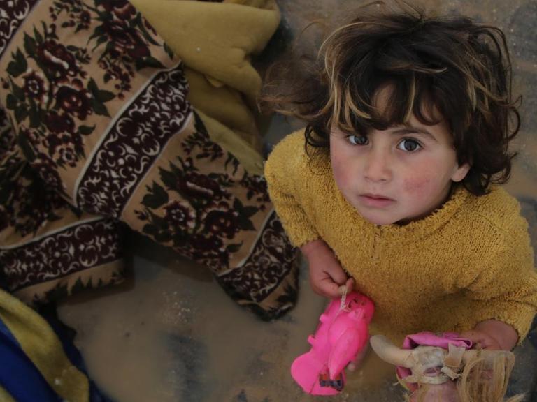 Ein syrisches Kind in Aleppo blickt ratlos.