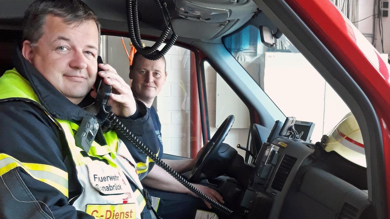 Jan Südmersen (l.) und Britta Lückener von der Feuerwehr Osnabrück sitzen in einem Einsatzwagen