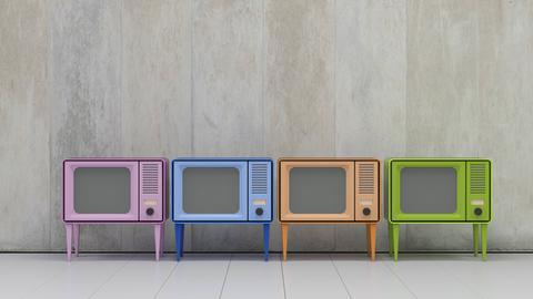 Vier Fernsehapparate im Retro-Style und in verschiedenen Farben stehen nebeneinander.