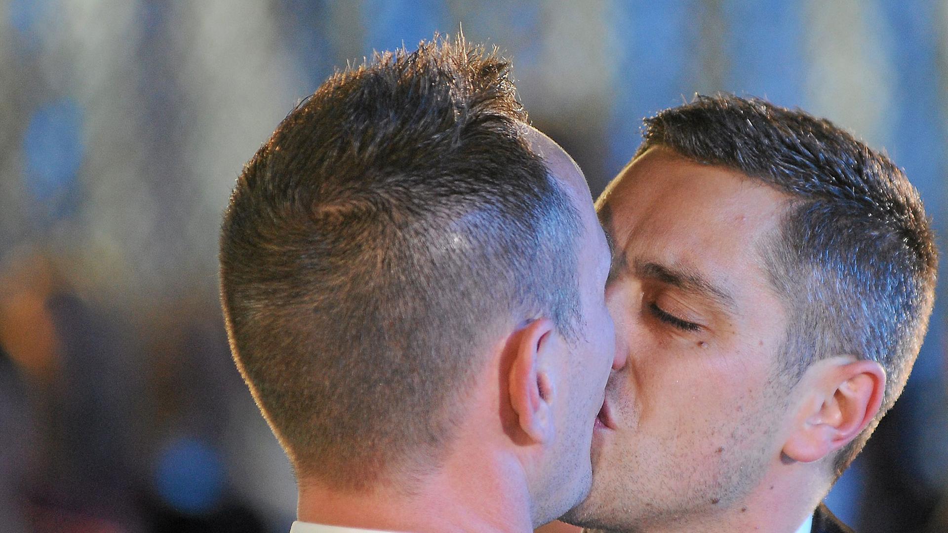 Vincent Autin und Bruno Boileau, Frankreichs erstes offiziell getrautes schwules Paar, küssen sich.