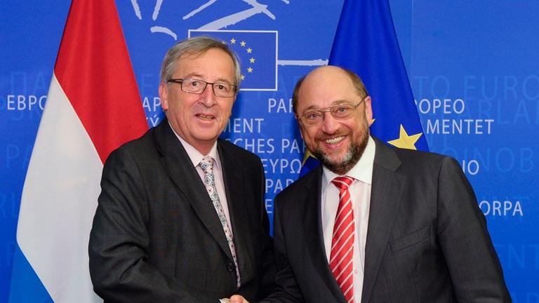 Jean-Claude Juncker und Martin Schulz schütteln sich die Hände
