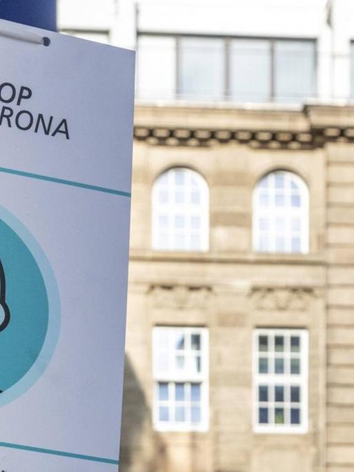 "Stop Corona" steht auf einem Hinweisschild in einer Fußgängerzone in der Innenstadt von Dortmund