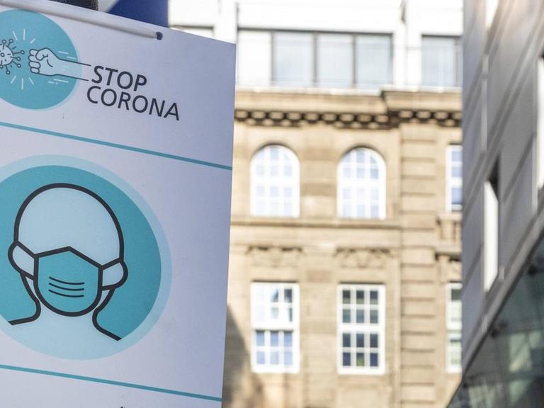 "Stop Corona" steht auf einem Hinweisschild in einer Fußgängerzone in der Innenstadt von Dortmund