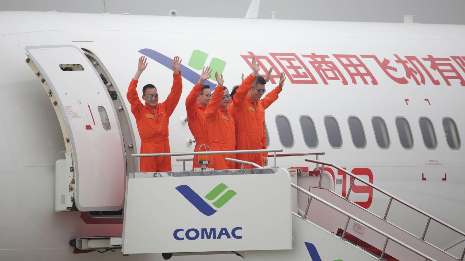 Crew-Mitglieder winken in Schanghai nach dem Jungfernflug der C919, dem ersten vom chinesischen Unternehmen COMAC entwickelten Großflugzeug am 25. Mai 2017. Gestartet war die Maschine in Pudong