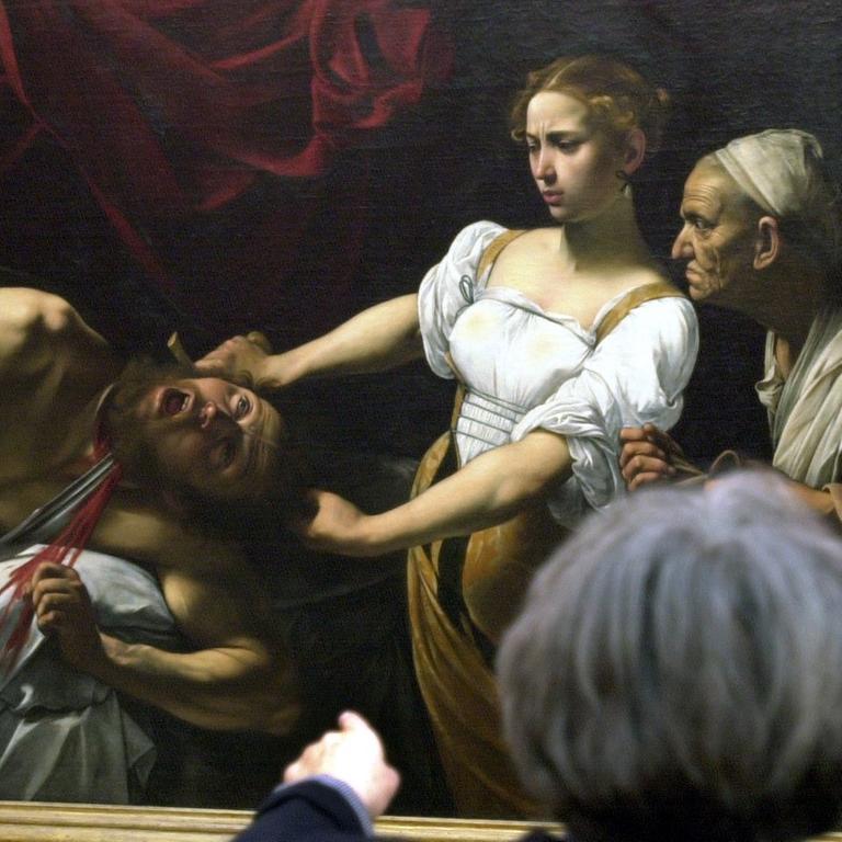Berlin: Museumsbesucher betrachten am 23.01.2001 das Gemälde"Judith enthauptet Holofernes" von Caravaggio in die Berliner Nationalgalerie. Das 1598/99 entstandene Meisterwerk ist eine Leihgabe aus dem Palazzo Barberini in Rom und wird erstmalig in Deutschland gezeigt. 