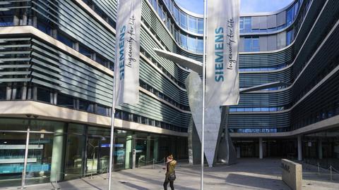 Vor dem Gebäude wehen Flaggen mit dem Schriftzug "Siemens".
