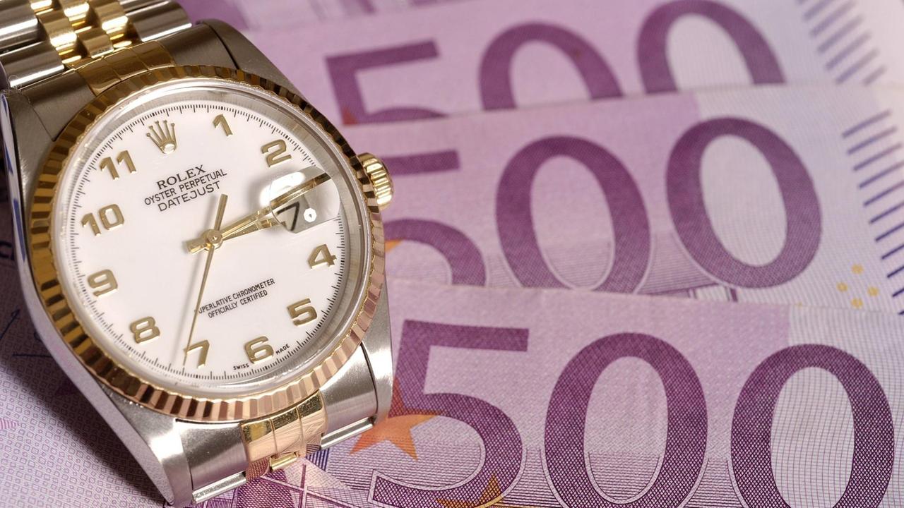 Eine Rolex auf mehreren 500 Euro Scheinen (Bild: imago stock&people)