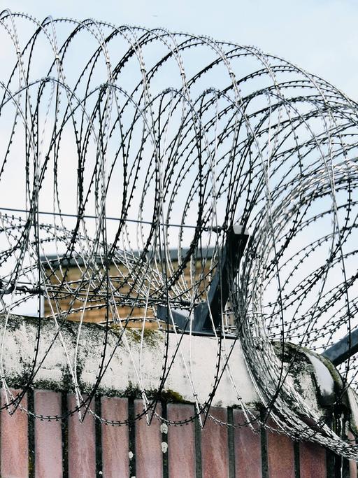 Gefängnismauer und Stacheldraht