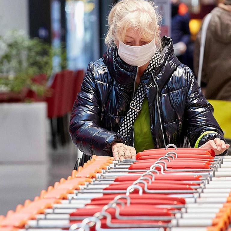 Eine Frau mit einer Stoffmaske in einem Supermarkt in Wien