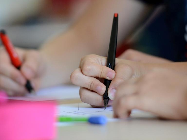 Schüler der Neckar-Realschule schreiben am 08.07.2013 in Nürtingen (Baden-Württemberg) während des Unterrichts. Foto: Franziska Kraufmann/dpa | Verwendung weltweit