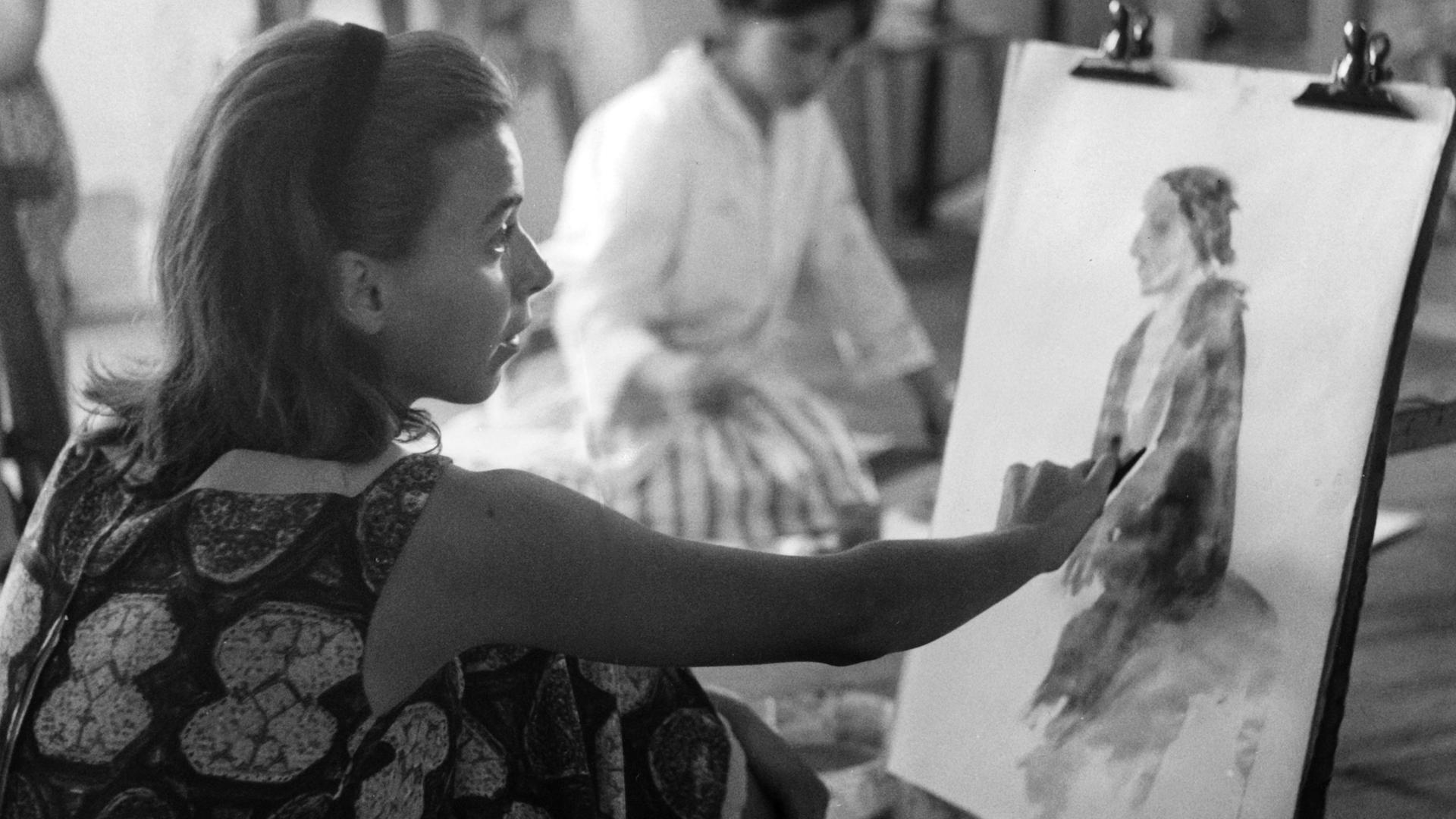 Contessa Maria Camilla Pallavicini malt an einem Bild von einer Frau. Im Hintergrund sieht man eine weitere Künstlerin.