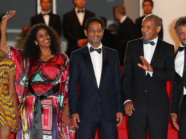 Haitian actress Kettly Noel, Niger actress Toulou Kiki, Tunisian actor Hichem Yacoubi, Mauritanian director Abderrahmane Sissako and Tunisian-born actor Abel Jafri pose as they arrives for the screening of their film "Timbuktu" at the 67th edition of the Cannes Film Festival in Cannes, southern France, on May 15, 2014.