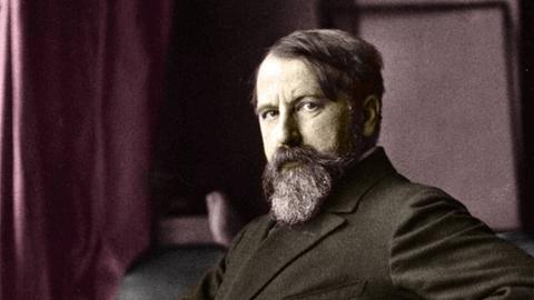 Zeitgenössisches Porträt von Arthur Schnitzler im Anzug, in selbstbewusster Pose mit der Hand in die Hüfte gestemmt.