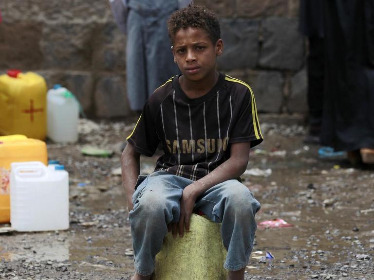 Eine Junge sitzt in der jemenitischen Hauptstadt Sanaa auf einem Wasserkanister.