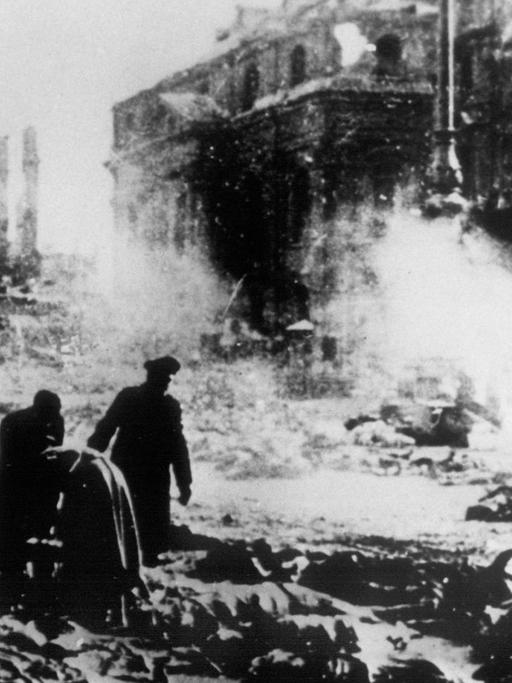 Nach den Bomenangriffen amerikanischer und britischer Flugzeuge auf Dresden am 13. und 14.02.1945 werden die zahlreichen Leichen, die auf der Straße liegen geborgen