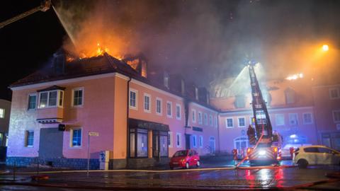 Ein Feuerwehrfahrzeug steht am 21.02.2016 in Bautzen (Sachsen) vor einem brennenden Haus. In einer geplanten Flüchtlingsunterkunft war in der Nacht zu Sonntag ein Feuer ausgebrochen. Foto: Rico Löb/dpa