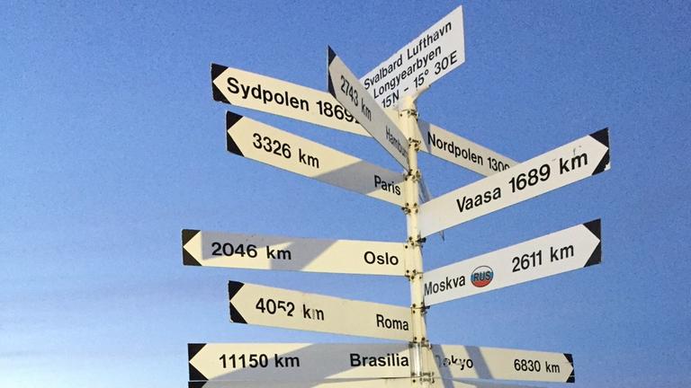Hoch im Norden und doch noch 1300 Kilometer bis zum Nordpol: Entfernungsschilder auf dem Flughafen von Spitzbergen