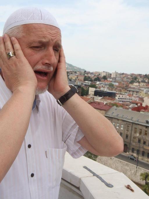 June 18, 2016 - Sarajevo, Bosnia and Herzegovina - A muezzin stands on Emperor s Mosque minaret and calls to noon prayer during the holy fasting month of Ramadan. Emperor s Mosque is the first Mosque built in Sarajevo (1457) after the Ottoman conquest of Bosnia.