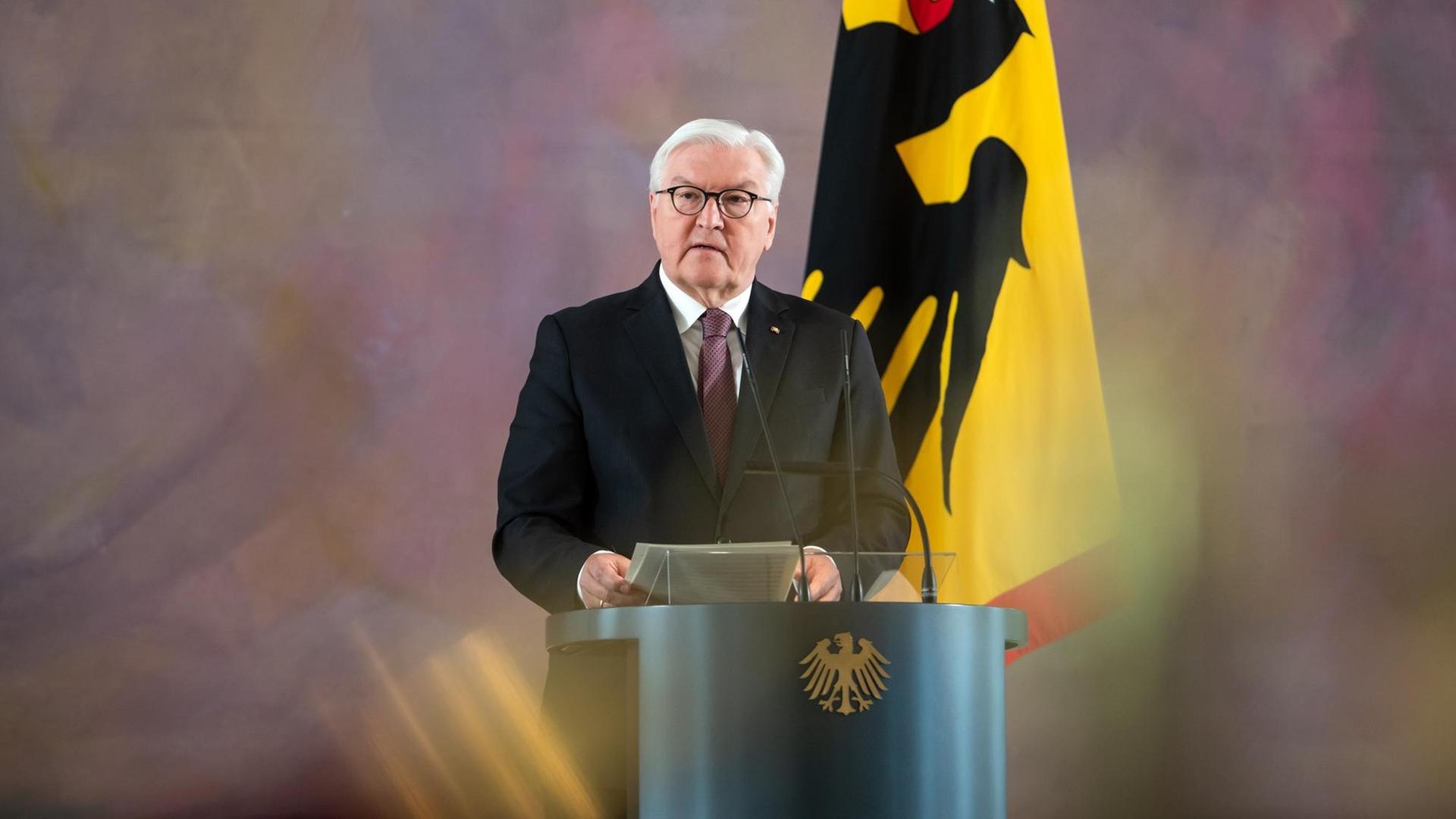 Bundespräsident Frank-Walter Steinmeier im Schloss Bellevue. Er steht hinter einem Rednerpult. 