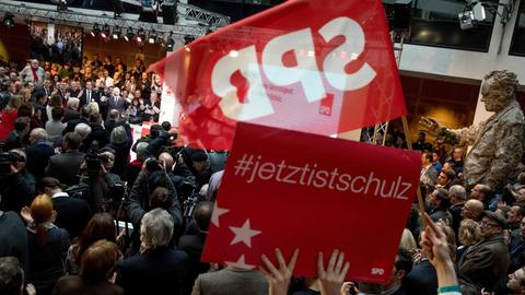 SPD-Anhänger schwenken eine Fahne und halten ein Schild mit der Aufschrift "Jetzt ist Schulz" hoch.