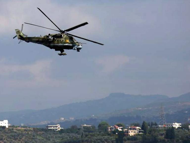 Ein russischer Helikopter fliegt über der Hmaimim-Militärbasis in Syrien