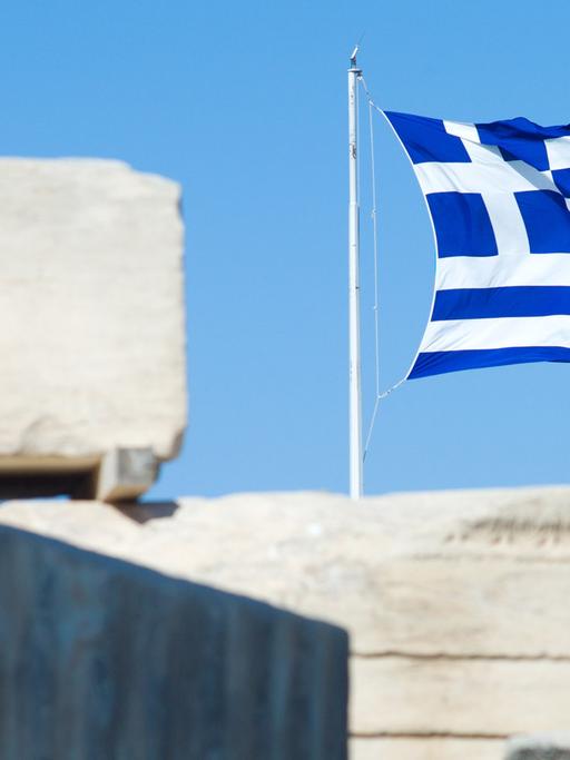 Die griechische Flagge weht am 20.07.2013 über der Akropolis in Athen.