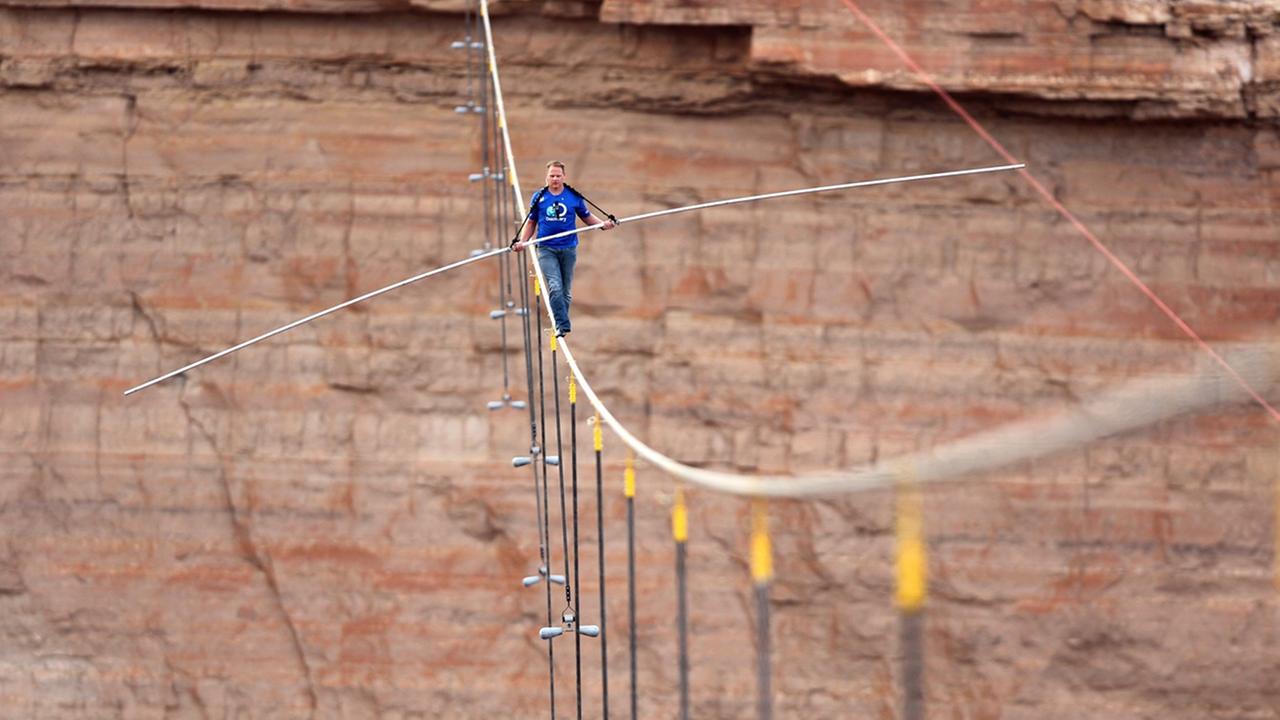 epa03757578 Handout image released by the Discovery Channel 24 June, 2013 showing Nik Wallenda balancing on a two-inch (5 cm) wire above the Little Colorado River in the Grand Canyon for Skywire Live With Nik Wallenda on Discovery Channel as he successful