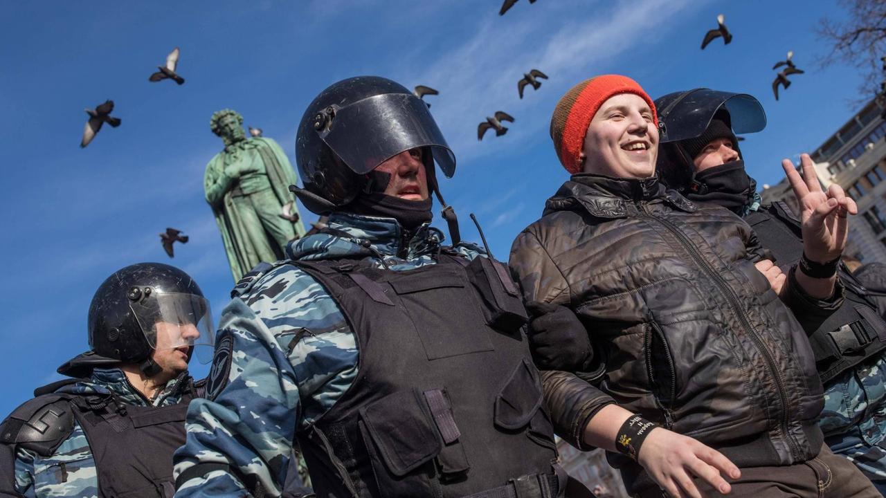 Polizisten in Moskau nehmen einen Mann während einer Demonstration gegen Korruption in Russland fest.