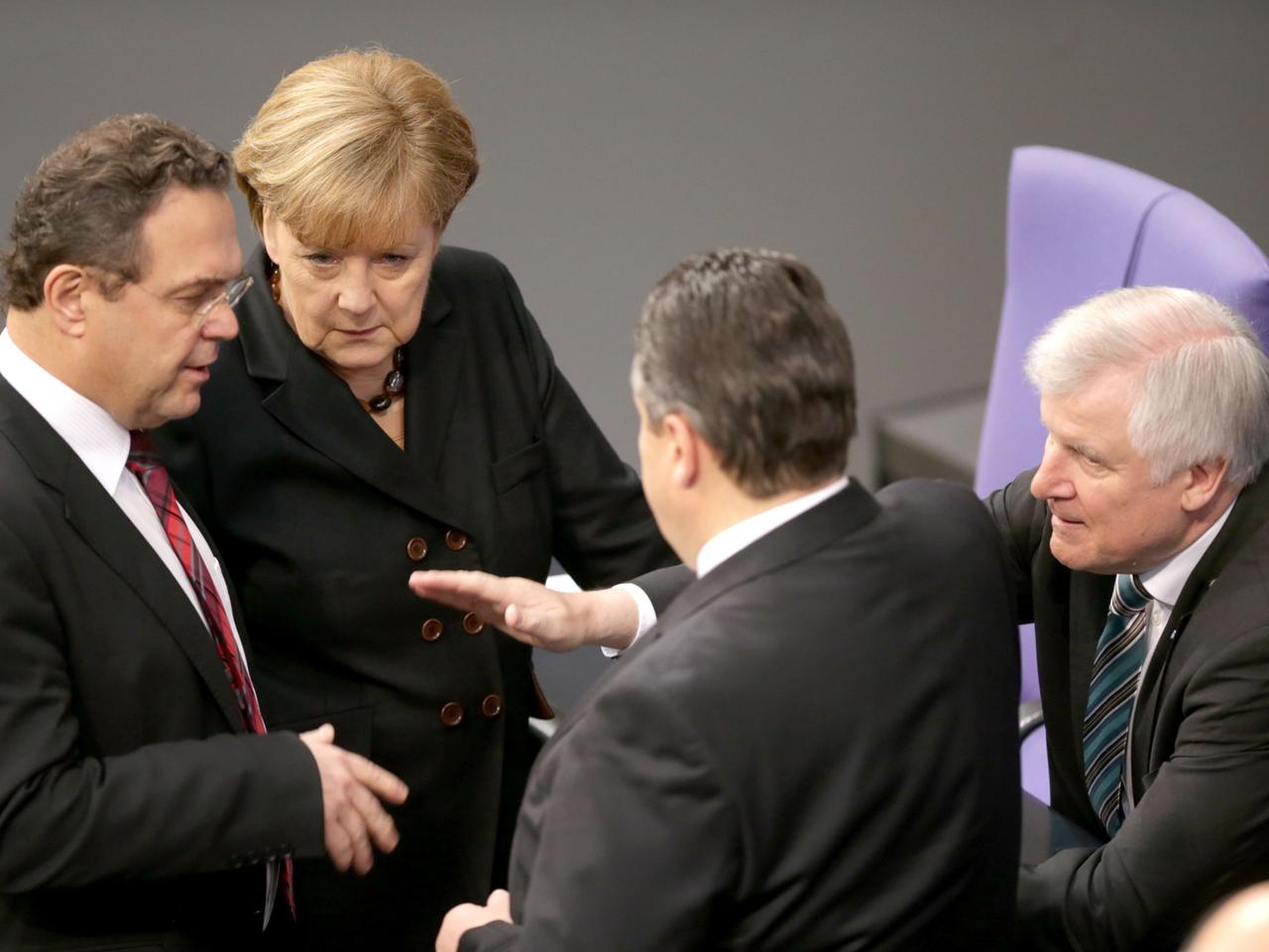 Friedrich, Merkel, Gabriel und Seehofer beraten sich im Bundestag.