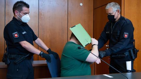 Einem Angeklagten (M) werden zum Prozessauftakt die Handschellen abgenommen. Der Mann aus dem Landkreis Northeim ist wegen schweren sexuellen Missbrauchs von Kindern und Jugendlichen sowie wegen Besitzes von kinderpornografischen Schriften angeklagt. Der Tatverdacht steht im Zusammenhang mit Ermittlungen zu den Vorkommnissen auf dem Campingplatz in Lügde (Nordrhein-Westfalen).