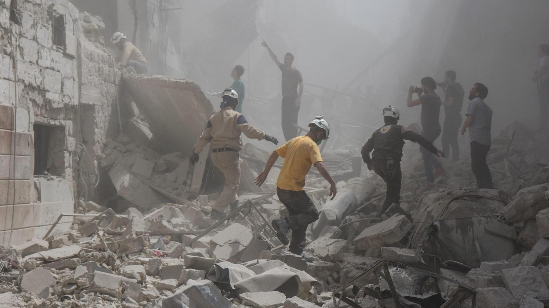 Menschen versuchen am 28.04.2016 in Aleppo (Syrien) Opfer unter den Trümmern eines Luftangriffs von der Nacht zuvor zu bergen. Bei dem Angriff wurde auch ein Krankenhaus schwer getroffen und mindestens 30 Menschen getötet.