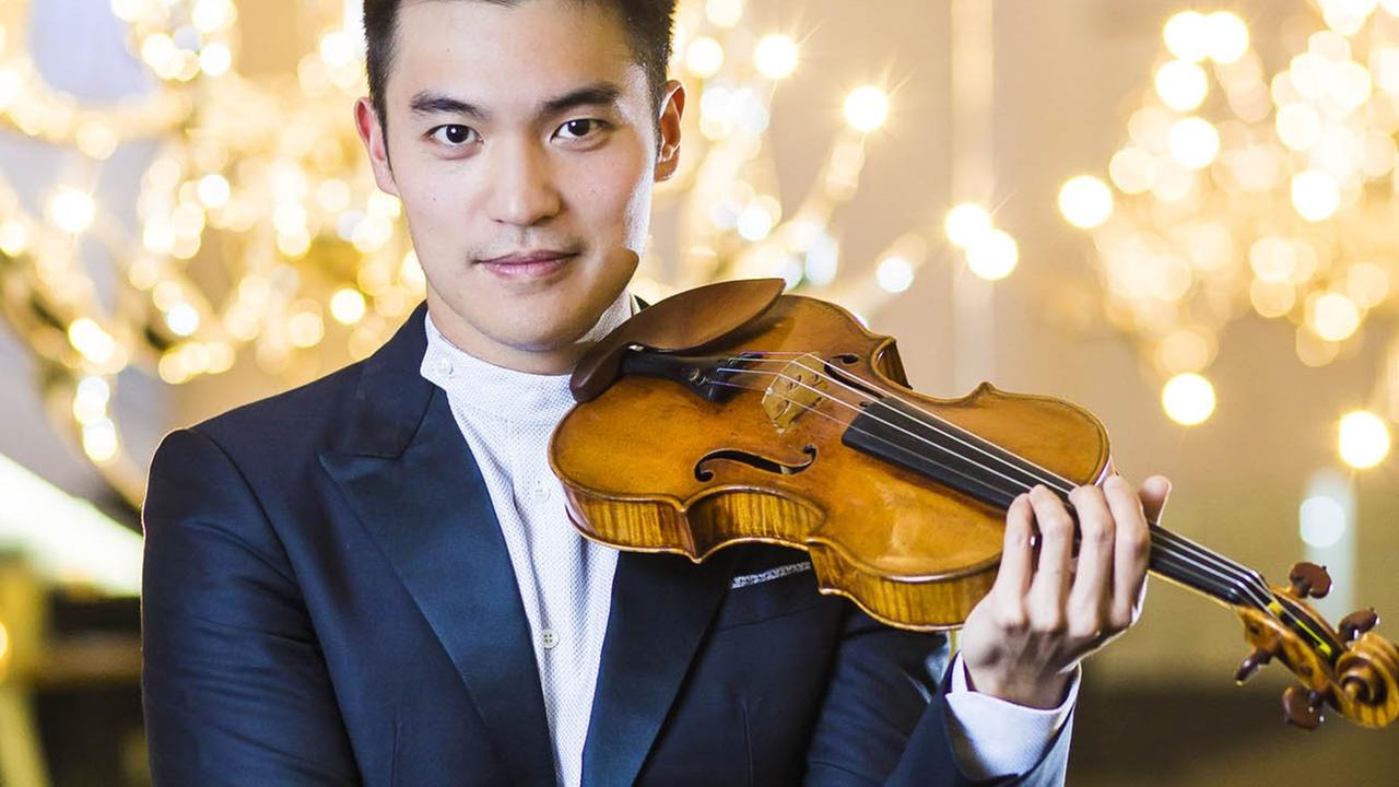 Der Geiger Chen Ray präsentiert in einem festlichen Raum seine Stradivari-Geige