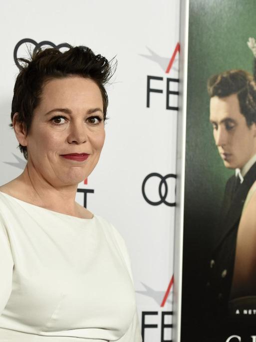 Die Schauspielerin Olivia Colman - in der Netflix-Serie "The Crown" spielt sie Queen Elisabeth II., hier bei einer Filmpremiere vor einem Plakat der Serie