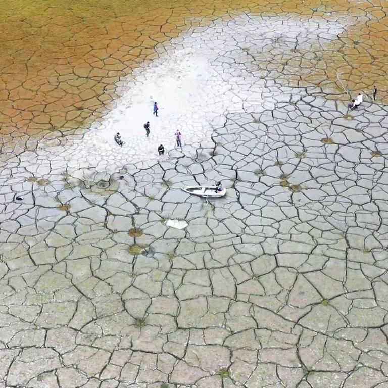 This photo taken by a drone and released by Nantou County Government, shows the dried lakebed of Sun Moon Lake in Nantou county in central Taiwan on April 23, 2021. Some households in Taiwan are going without running water two days a week after a months-long drought dried up the island's reservoirs and a popular tourist lake. (Nantou County Government via AP)