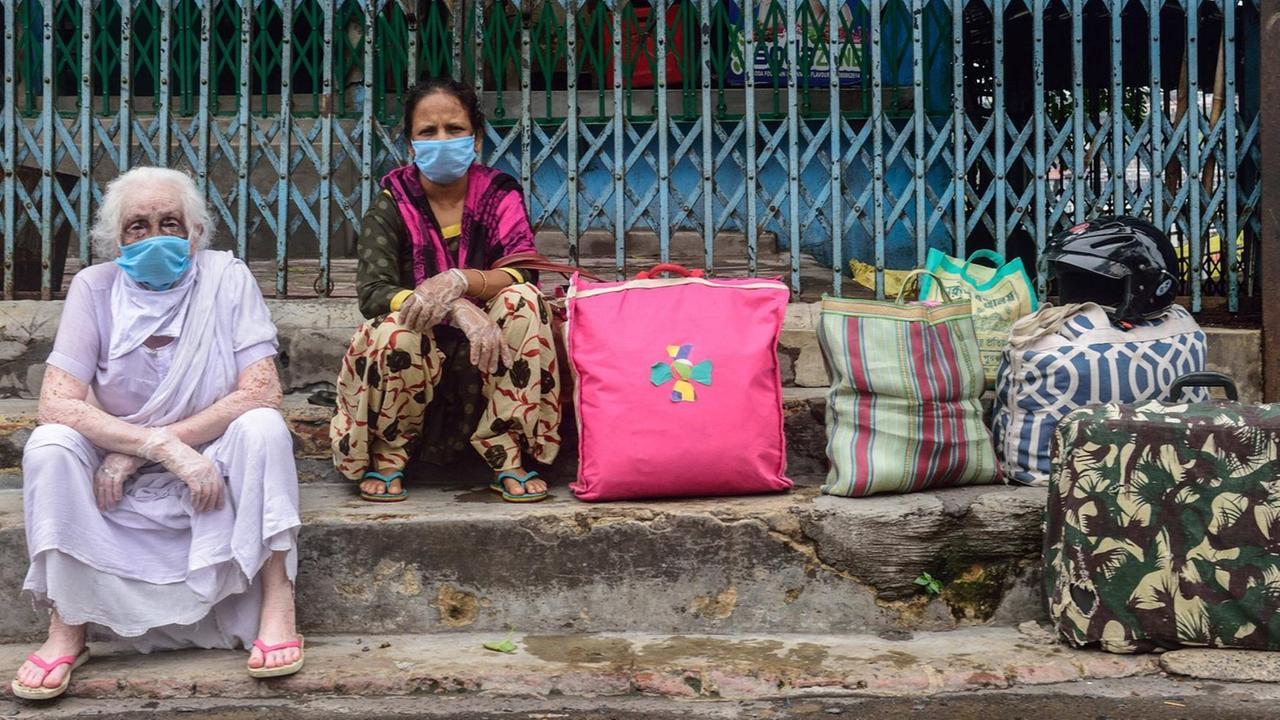 July 23, 2020, Kolkata, India: Women wearing face masks are seen stranded in Howrah station due to the unavailability of public transport during the two day a week lockdown in Kolkata..West Bengal government decided to impose a week lockdown in the state to curb the rise of the Coronavirus COVID-19 disease. Only persons in emergency services and patients have the permission to travel or make movements. Kolkata India - ZUMAs197 20200723_zaa_s197_054 Copyright: xSumitxSanyalx