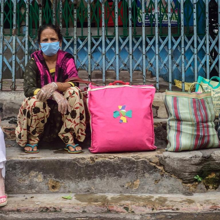 July 23, 2020, Kolkata, India: Women wearing face masks are seen stranded in Howrah station due to the unavailability of public transport during the two day a week lockdown in Kolkata..West Bengal government decided to impose a week lockdown in the state to curb the rise of the Coronavirus COVID-19 disease. Only persons in emergency services and patients have the permission to travel or make movements. Kolkata India - ZUMAs197 20200723_zaa_s197_054 Copyright: xSumitxSanyalx