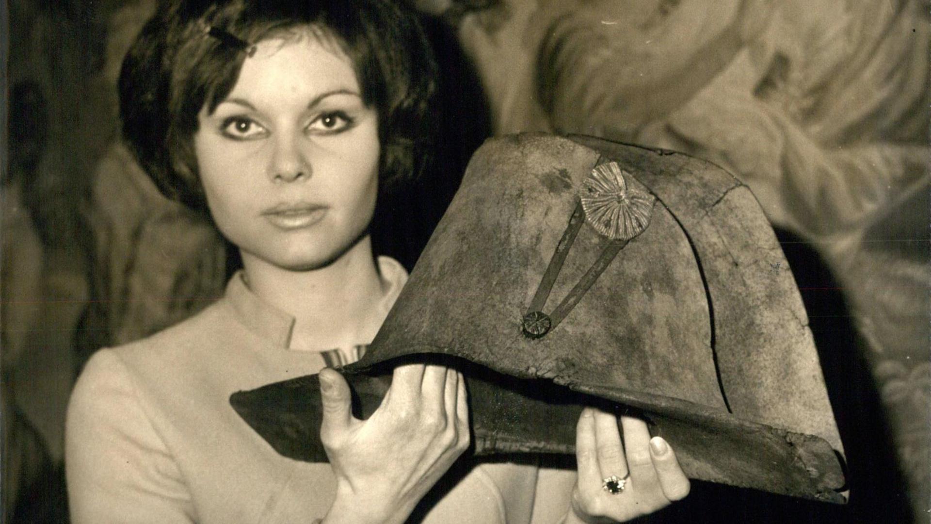 Eine junge Frau hält den legendären Zweispitz-Hut von Napoleon Bonaparte