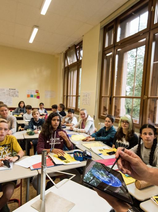 Friedrich-Gymnasium in Freiburg / Baden-Württemberg: Physiklehrer Patrick Bronner unterrichtet seine Klasse in einem Pilotprojekt mit einem Tabletcomputer. Die Schüler erarbeiten Ergebnisse mit dem Smartphone.