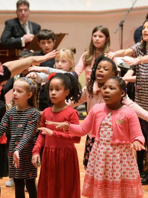 Kinder des Bildungsprogramms SING singen und performen auf einer Bühne