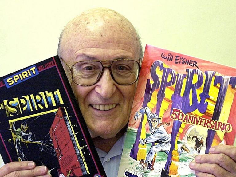 Der US-Comic-Zeichner Will Eisner, Schöpfer des Comics "The Spirit", posiert am 9.5.2003 auf der Comic-Messe in Barelona in Spanien mit zwei Spirit-Hefen.