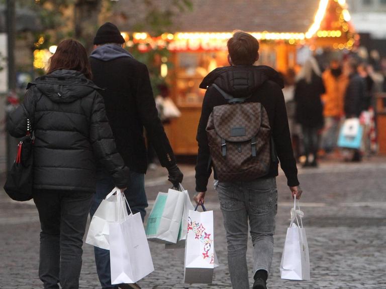 Am zweiten Adventssamstag tragen Passanten Papiertüten mit Einkäufen in der Innenstadt von Frankfurt, Hessen, Deutschland