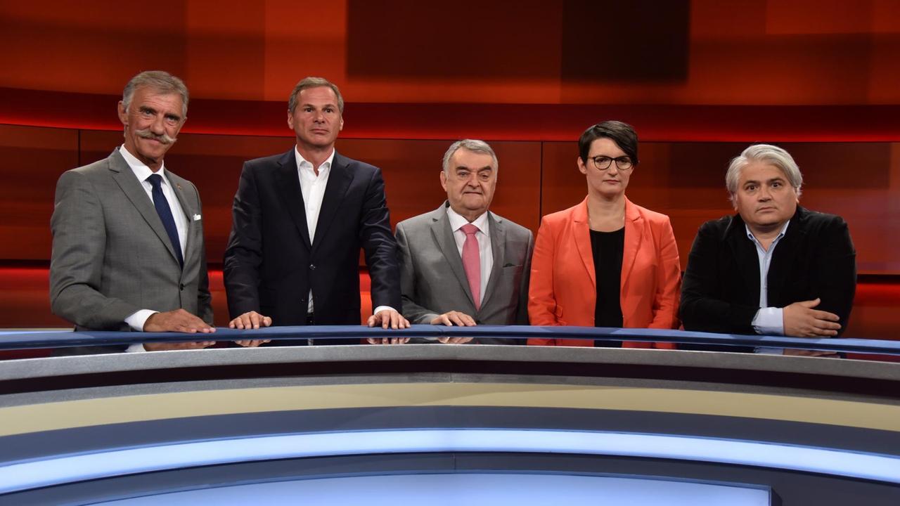 Von links nach rechts stehen an einem halbrunden Tisch im Fernsehstudio: Uwe Junge (AfD), Georg Mascolo (Journalist), Herbert Reul (CDU), Irene Mihalic (Grüne) und Mehmet Daimagüler (Rechtsanwalt).