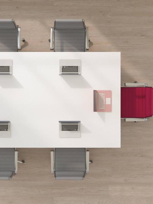 Eine Illustration zeigt einen Konferenztisch, an dem ein Platz farblich heraussticht.